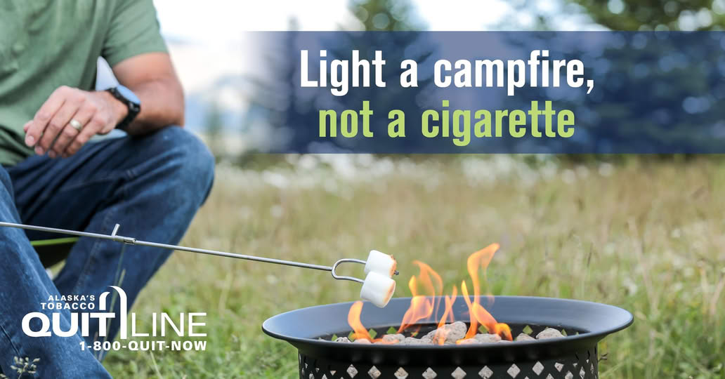 Man outside by a fire pit with the words “Light a campfire, not a cigarette.”